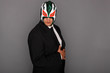 Man wearing a suit and luchador mask.