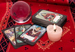 Tarot cards and crystal ball on red cloth