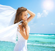 Photo: Girl With White Scarf on The Beach. Travel and Vacation Girl With White Scarf on The Beach. Travel and Vacation