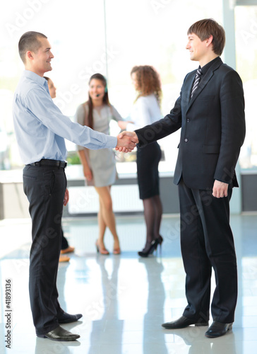 Photo: Business people shaking hands, finishing up a meeting Business people shaking hands, finishing up a meeting