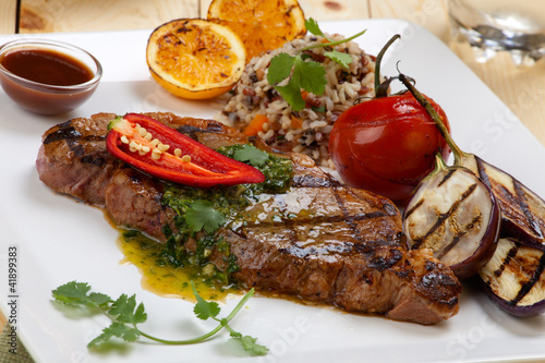 Photo: Piece of Medium Rare Steak with Spicy Herb Sauce Piece of Medium Rare Steak with Spicy Herb Sauce