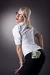 young blond woman show money in jeans