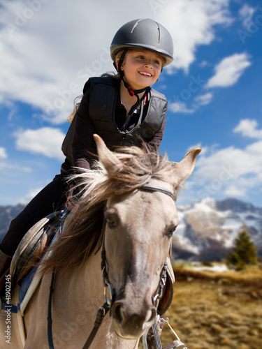 Photo: Horse riding - portrait of lovely equestrian on a horse Horse riding - portrait of lovely equestrian on a horse
