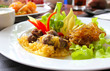 Thai food, rice in cold water served with fried sweet pork,fried