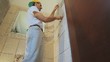 tiler installing tiles in a bathroom