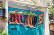 Photo: Old boots used as flower pots on the entrance door of a house Old boots used as flower pots on the entrance door of a house