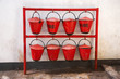 old red fire buckets hanging on support