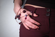female hand wearing adornment touching the waist