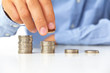 Hand put coin to stack, investment concept
