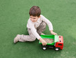 boy plays with toy car