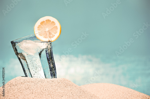 Photo: Cold drink on the beach on a hot summer day Cold drink on the beach on a hot summer day