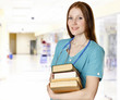 Photo: Smiling female doctor with books Smiling female doctor with books