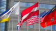 Flags of  various states on  background of  business center