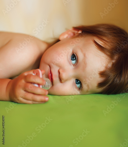Photo: Cute baby girl with a soother in her mouth Cute baby girl with a soother in her mouth