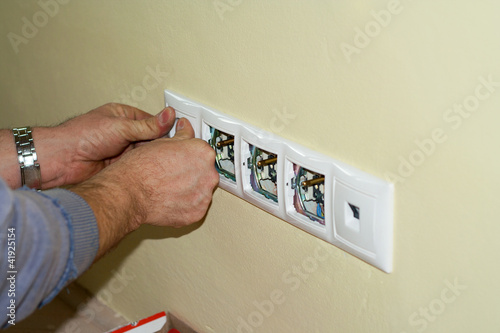 Photo: Electrician completes the socket at 230 volts Electrician completes the socket at 230 volts