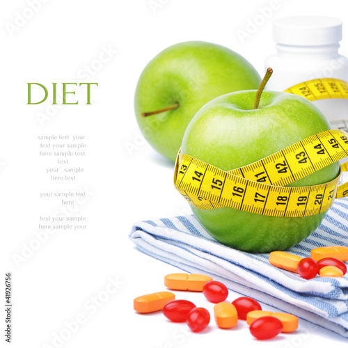 Photo: Green apples, vitamins and measuring tape Green apples, vitamins and measuring tape
