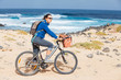 Woman riding bike on a beach Woman riding bike on a beach