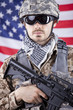 Soldier with gun over american flag