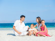 Family of four on tropical beach