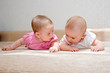 Photo: Two sisters, twin baby girls talking and lying together Two sisters, twin baby girls talking and lying together