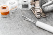 The sewing machine, threads and thimbles on a fabric.