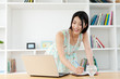 Beautiful young woman using a laptop computer