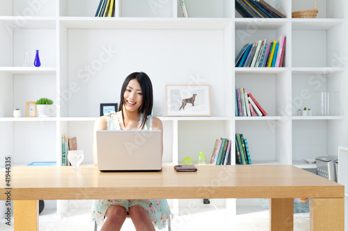 Photo: Beautiful young woman using a laptop computer Beautiful young woman using a laptop computer