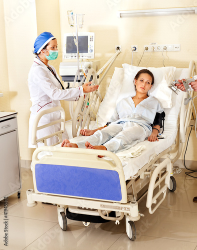 Photo: Doctor treats patient with defibrillator. Doctor treats patient with defibrillator.