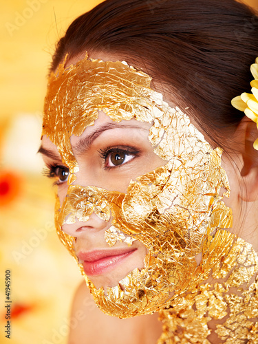 Photo: Woman getting facial mask . Woman getting facial mask .