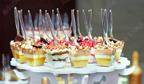 Photo: many servings of sweet tasty dessert on buffet many servings of sweet tasty dessert on buffet