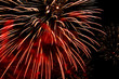 Fireworks flash in the black sky