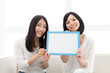 Beautiful young women with message board