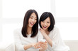 Photo: Beautiful young women using a moblie phone Beautiful young women using a moblie phone