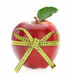 Diet concept. Apple with measuring tape Diet concept. Apple with measuring tape