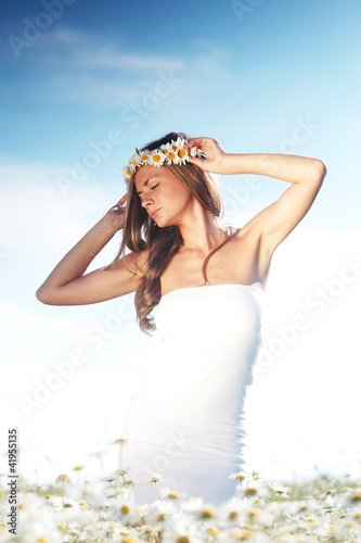 Photo: girl in dress on the daisy flowers field girl in dress on the daisy flowers field