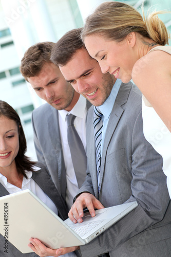Photo: Business team consulting program on laptop Business team consulting program on laptop