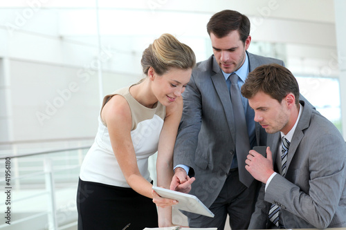 Photo: Group of business people meeting around table Group of business people meeting around table