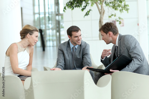 Photo: Business people meeting in airport lounge Business people meeting in airport lounge