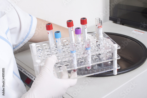 Photo: Hands loads blood samples in centrifuge Hands loads blood samples in centrifuge
