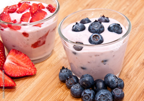 Photo: Mixed Yoghurts on wooden background Mixed Yoghurts on wooden background