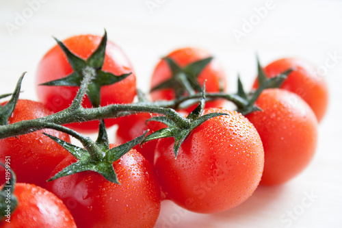 Photo: cherry tomatoes on branch cherry tomatoes on branch