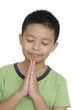 Young boy praying on a white background