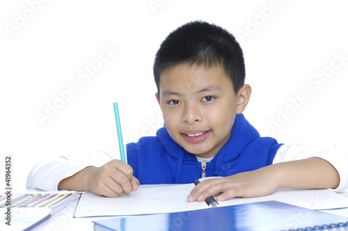Photo: A shot of an asian kid studying at home A shot of an asian kid studying at home