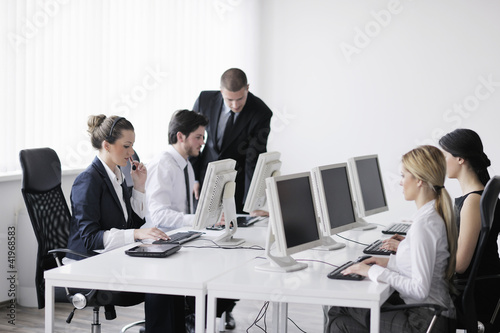 Photo: business people group working in customer and help desk office business people group working in customer and help desk office