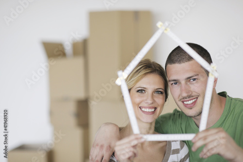 Photo: Young couple moving in new home Young couple moving in new home