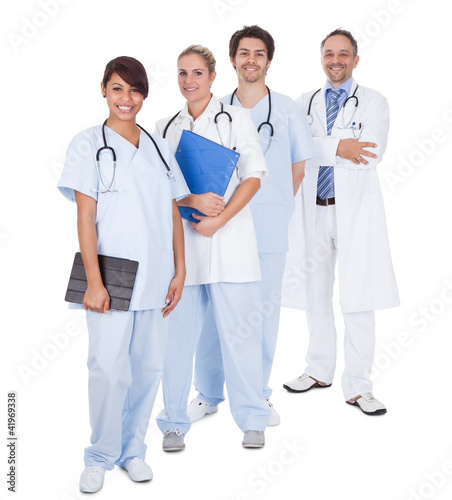 Photo: Group of doctors standing together over white Group of doctors standing together over white