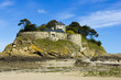 Landscape, seascape with beach and a house on top of a rock.