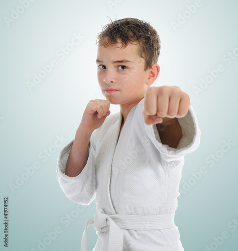 Photo: Young boy training karate. Young boy training karate.