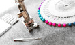 The sewing machine and needles on a fabric.