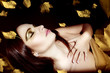 Photo: Beautiful young woman over autumn background Beautiful young woman over autumn background